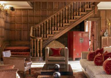 Inside hotel lounge with wooden panelled walls .
