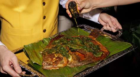 Whole roasted turbot on a silver tray.