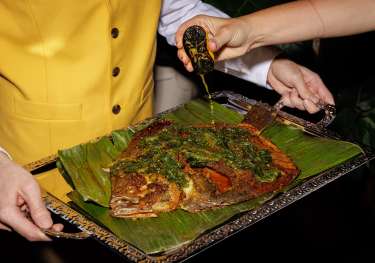 Whole roasted turbot on a silver tray.