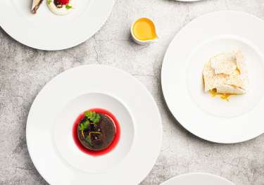 An array of dishes on grey table.