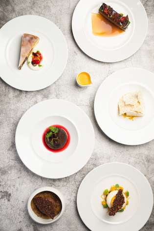 An array of dishes on grey table.