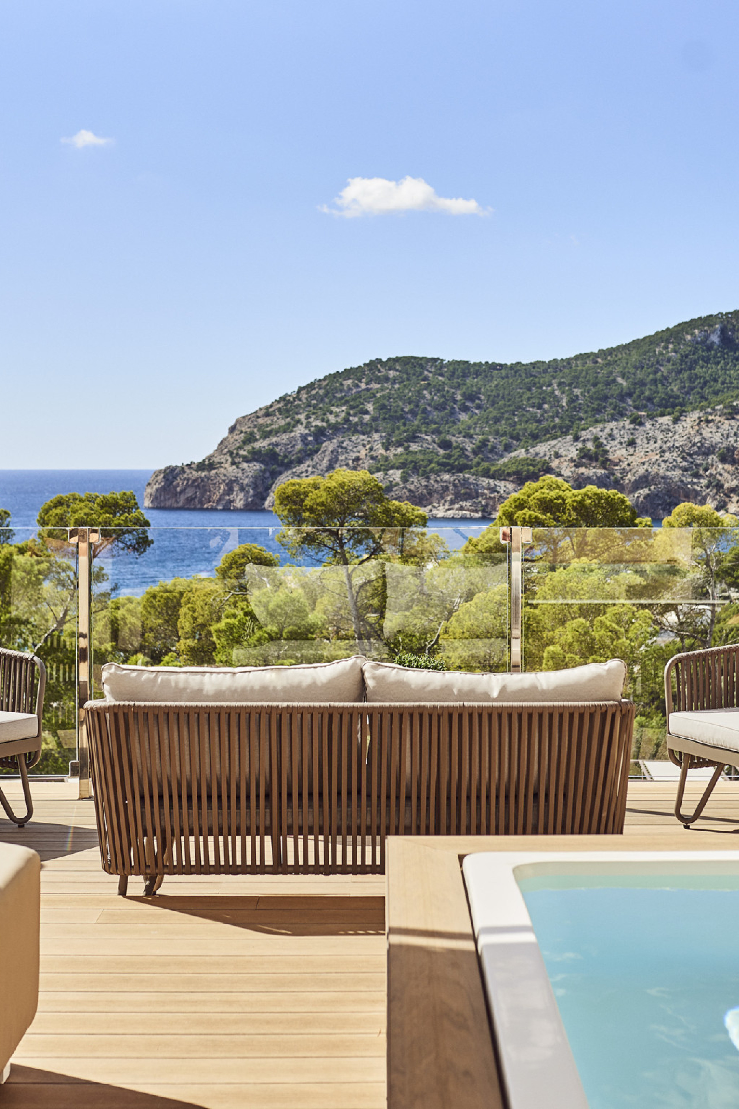 hotel penthouse balcony area with seating and raised pool