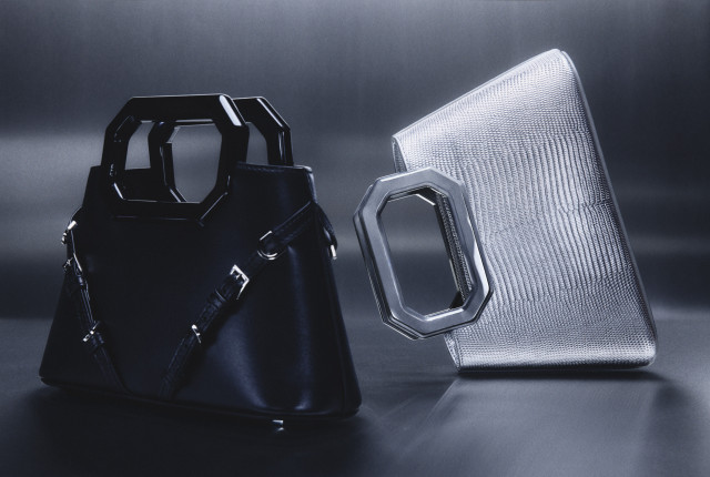 black bag next to silver handbag on its side