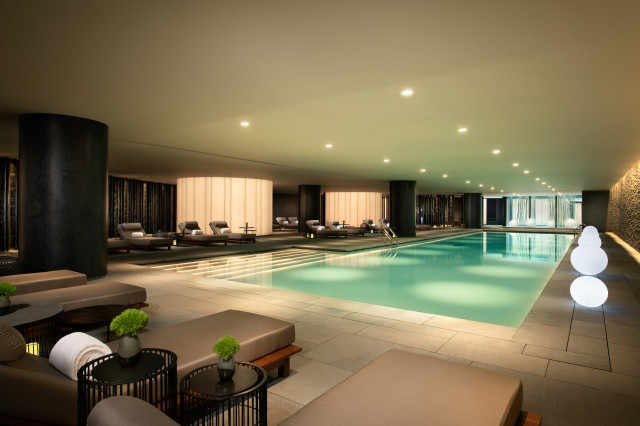 indoor hotel swimming pool with loungers