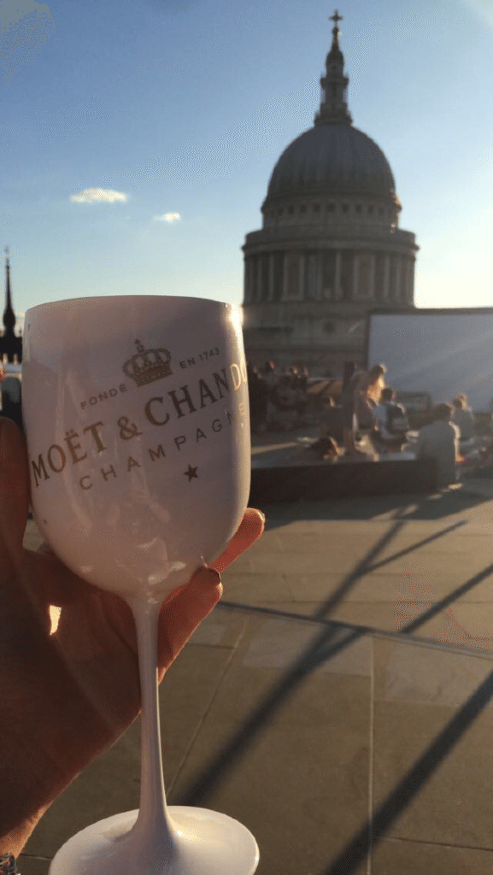 woman holding a moet champagne flute on London rooftop terrace