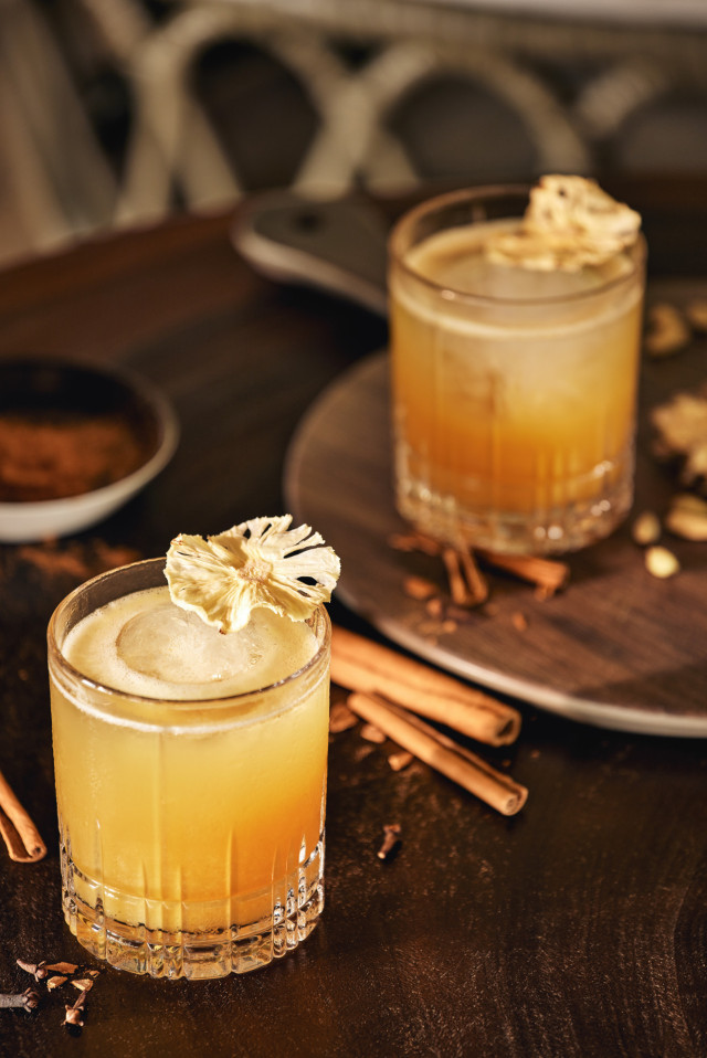 two fruity cocktails on table inside hotel 