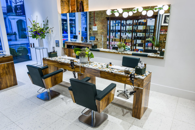 inside hair salon with mirrors against the wall 