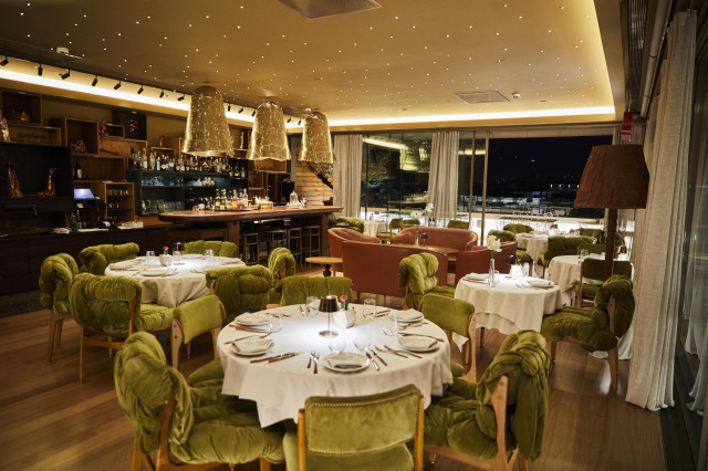 hotel restaurant at night with green velvet chairs