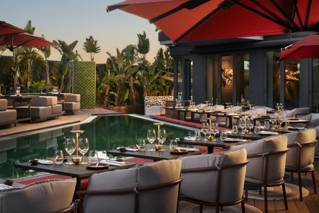 hotel restaurant beside pool with red umbrellas