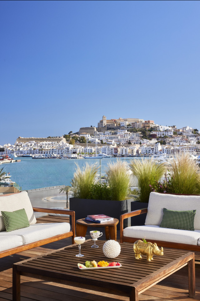 hotel balcony with seating and view of ibiza
