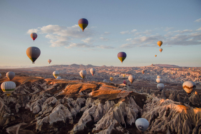 hot air balloons over rural turkey