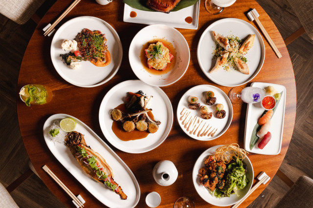 plates of food on round wooden table at nobu marrakech
