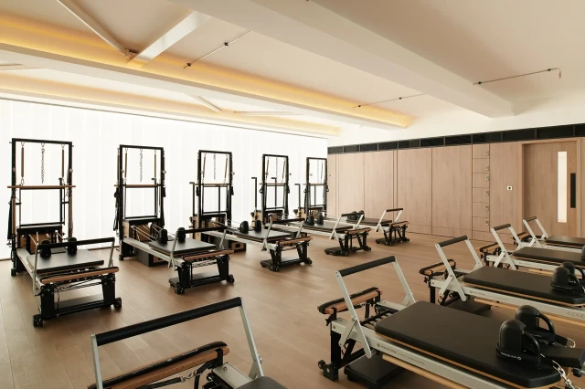 Pilates reformers in modern studio.