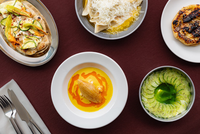 five dishes laid on red table in restaurant