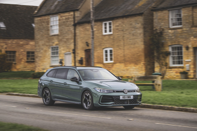 vw passat ehybrid driving past houses
