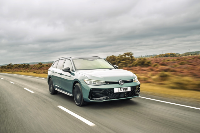 vw passat ehybrid car driving along a road in the countryside