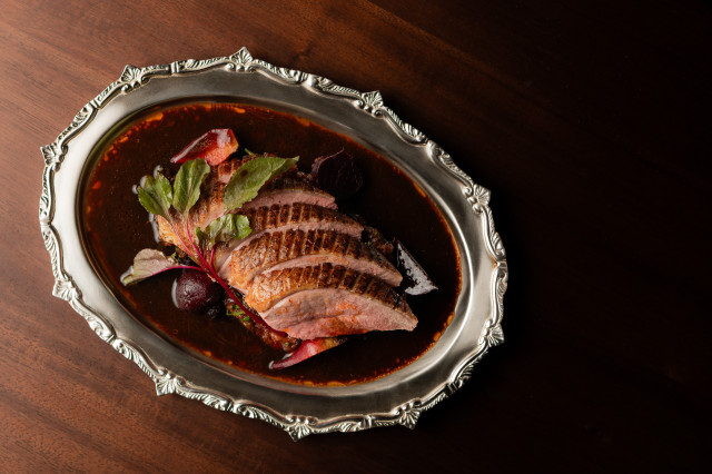 sliced meat on silver dish with beetroot 