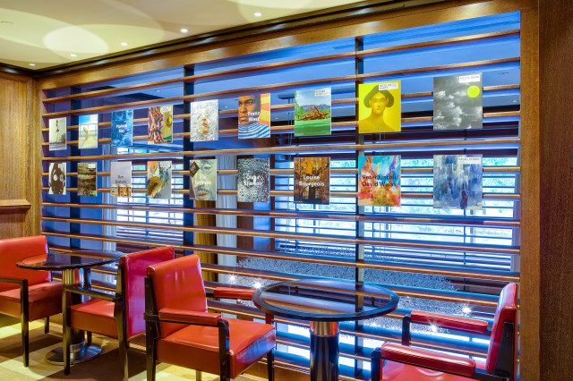 hotel interior with prints on glass wall and wooden slats