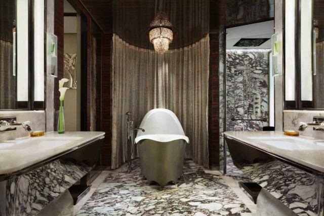 hotel bathroom with free-standing tub and lots of marble