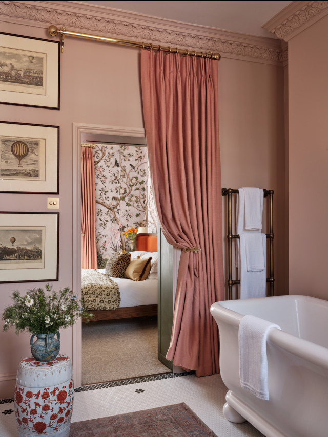 pink bathroom with bath tub and pink curtain