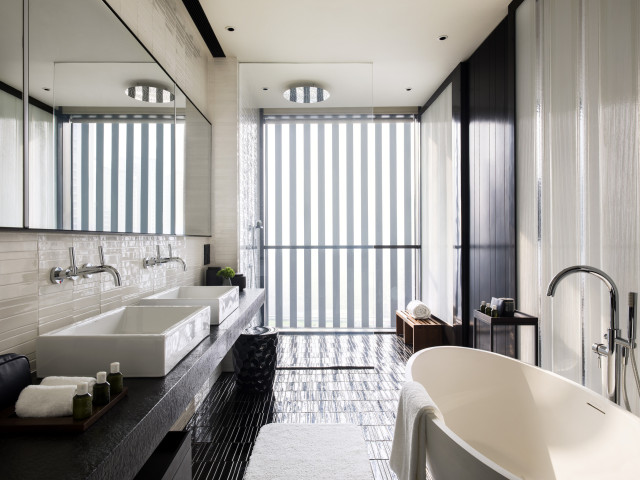 luxury hotel bedroom with glass mirrors and large window 