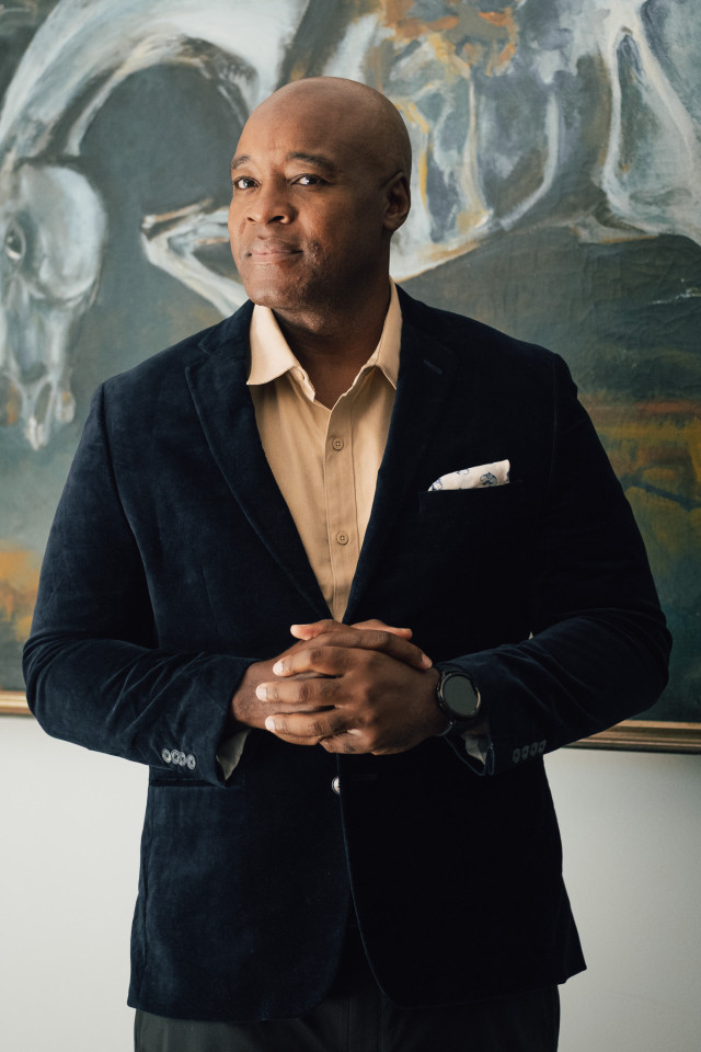 headshot of ronald ndoro mind posing in velvet blazer 