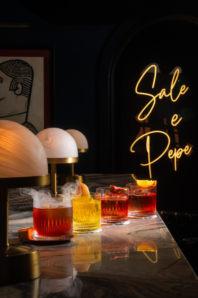 four cocktails arranged on a marble countertop at sale e pepe