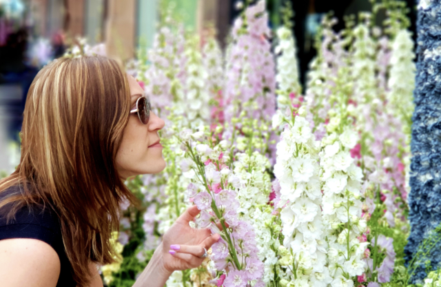 Woman smelling flowers at the RHS Chelsea Flower Show