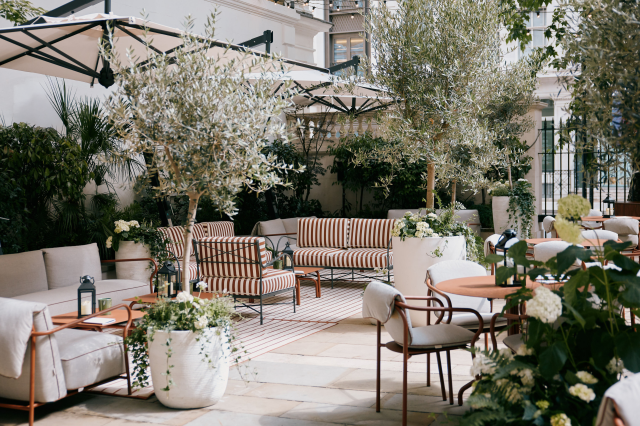 outdoor terrace bar in London with pot plants and striped furniture