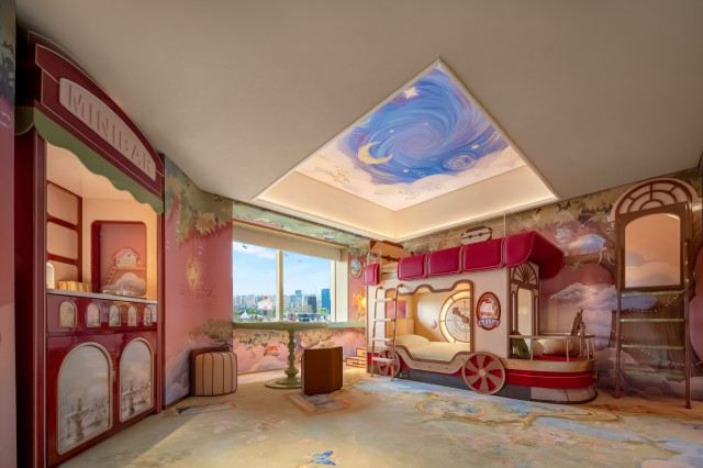 family suite with pink accents and ceiling illustrations 