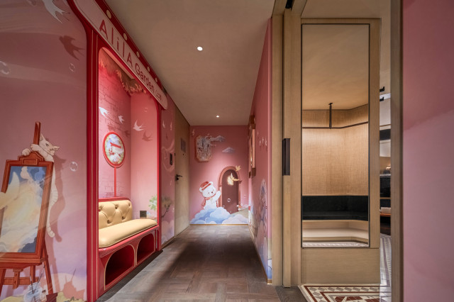 family suite with pink walls and playful illustrations