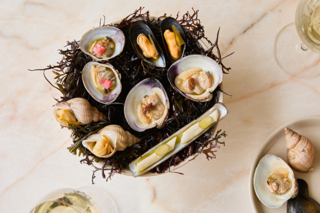shellfish served on bed of seaweed