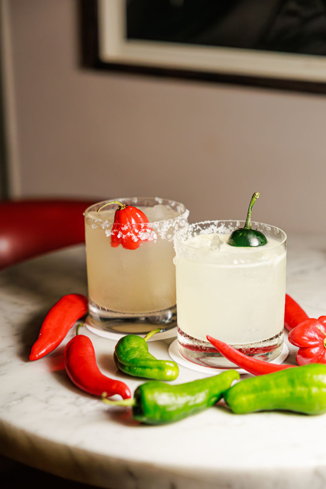 two spicy margaritas on marble table