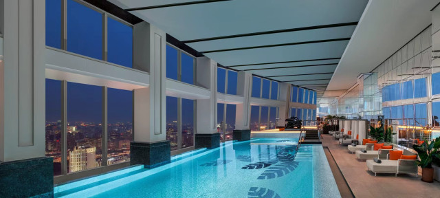 indoor hotel swimming pool with views of shanghai below