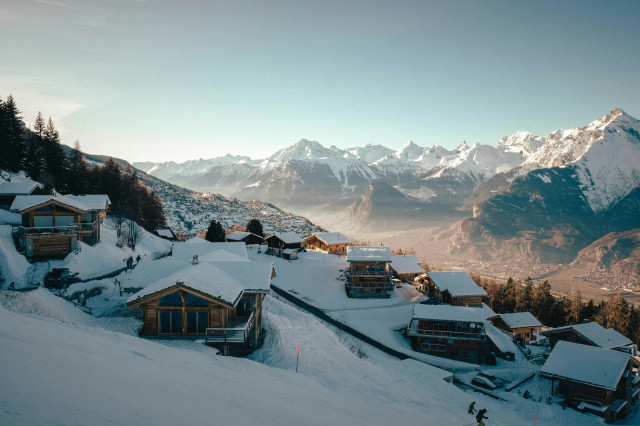 panoramic photo of chalets with mountain view in switzerland