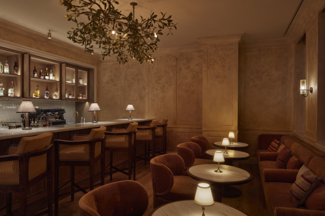 bar with low lighting and plush velvet seats 