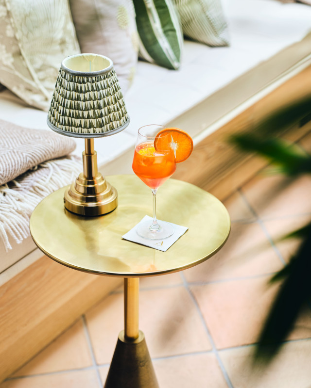 round table with lamp and drink 