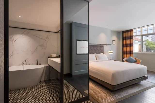 photo of hotel suite with double bed and bath tub