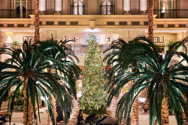the landmark london hotel with palm trees and christmas tree