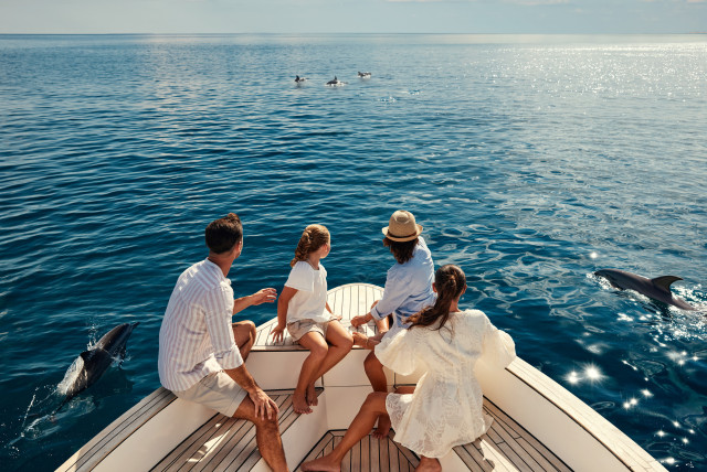 family of four whale watching at st regis maldives 