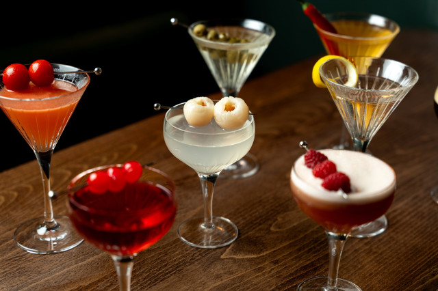 selection of martinis arranged on wooden countertop