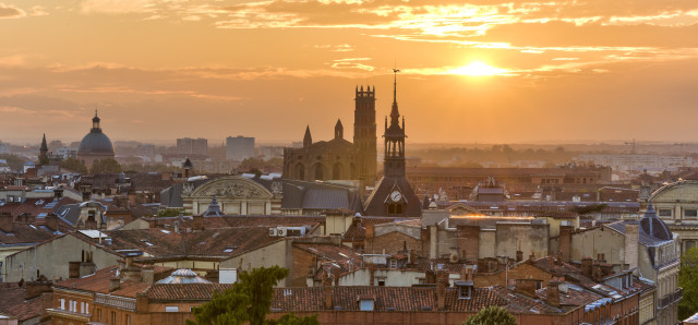 Toulouse rooftops with setting sun