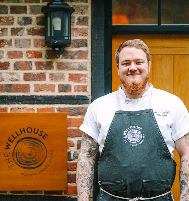 chef tom younger posing outside the wellhouse restaurant 
