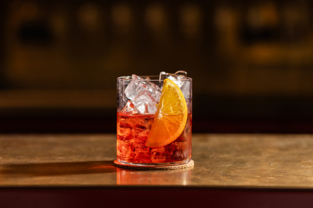 negroni cocktail with slice of orange at bar tozi 