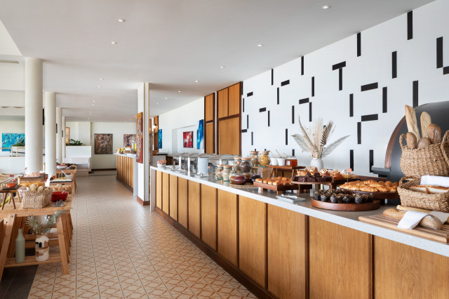 hotel breakfast buffet with fresh bread and pastries
