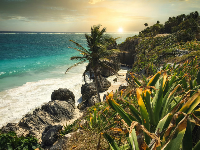 coastal photo of tulum with blue sea and rugged coastline