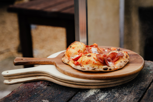 woodfired pizza on wooden board 