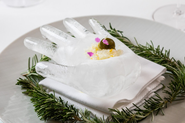 restaurant dish served on block of hand-shaped ice