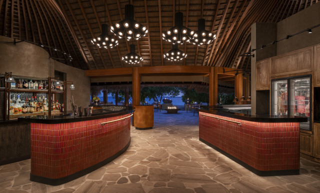w maldives' fire restaurant with red tiles and warm lighting