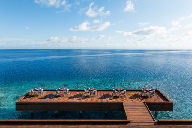 w maldives' fish restaurant on a jetty overlooking the sea